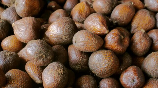 Tropical Closeup of Salak salacca zalacca Fruit Bunches, Emphasizing Their Distinct Sweet and Tart Flavor at a Local Stall.