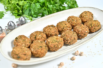 Closeup of fried shrimp balls on wooden tray with scattered soy beans