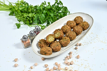 Closeup of fried shrimp balls on wooden tray with scattered soy beans
