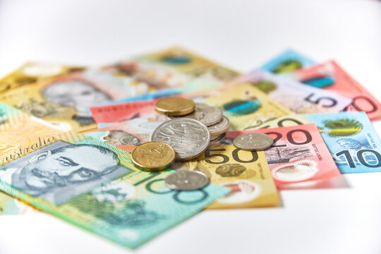 Collection of Australian banknotes and coins scattered on a flat surface