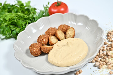 White plate with a small plate and beans beside it