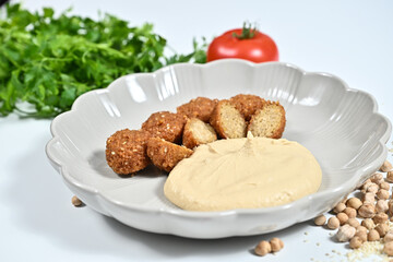 White plate with a small plate and beans beside it