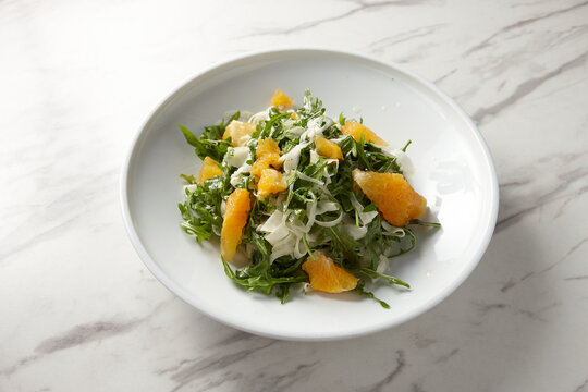green salad with orange slices and grated cheese