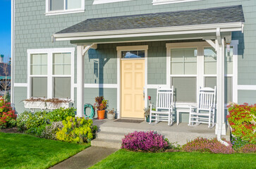 Entrance of grey painted luxury house in summer with stair steps and nice landscape in Vancouver, Canada, North America. Day time on June 2024