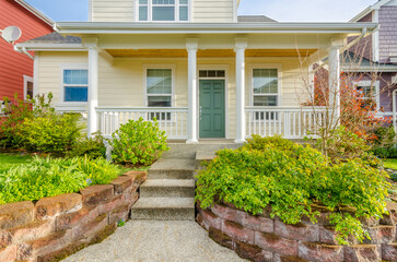 Entrance of grey painted luxury house in summer with stair steps and nice landscape in Vancouver,...