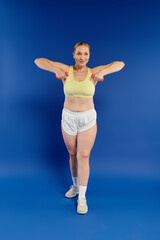 Fototapeta premium A pretty woman exercises diligently in a studio setting, showcasing her dedication to fitness and wellness.