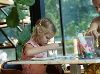  A young mother and her daughter enjoy a creative art session at home 