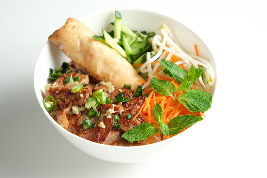 Bun Cha Gio bowl with meat slices topped with fried spring roll.