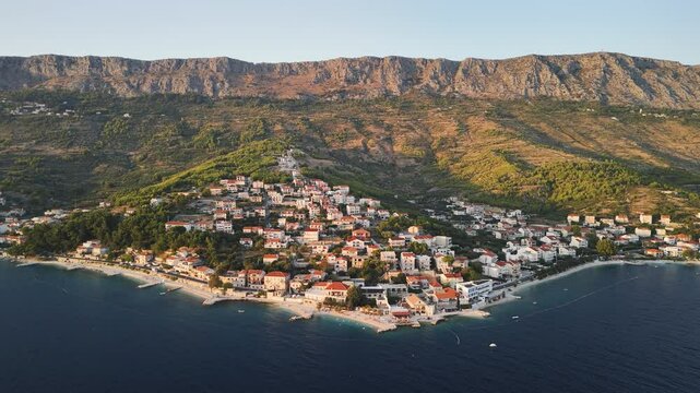 Aerial view of the small village Dugi Rat during golden hour. Summer vacations in Croatia