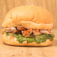 Burger with lettuce and Chicken on a background.
