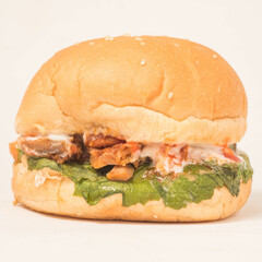 Burger with lettuce and Chicken on a background.
