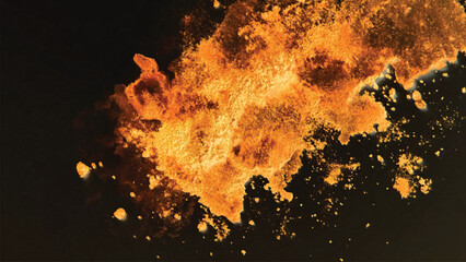 abstract powder splatted background. Orange powder explosion on black background. Colored cloud. Colorful dust explode. Paint Holi.