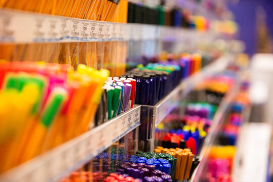 close up of rows of pens for sale with a blurry background