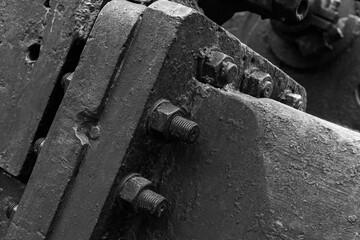Massive parts of vintage black industrial machine, close up