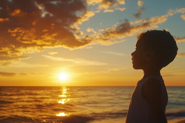 Fototapeta premium Child watching the sunset on the beach, peaceful expression, golden sky, horizon, silhouette, side view 2