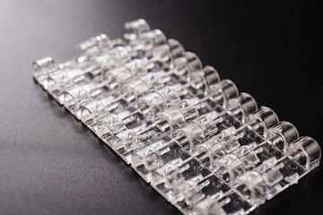 Lots of clear plastic wire holders on the black surface. details for a comfortable life and aesthetics.