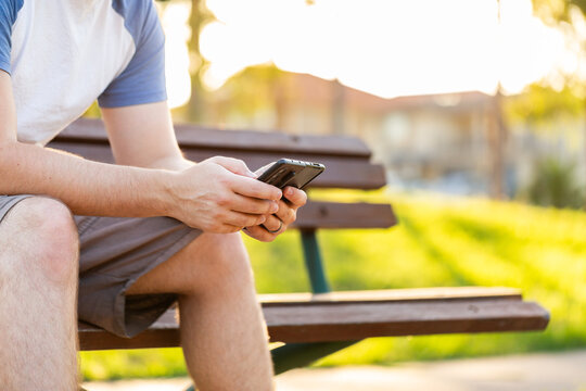 Person sitting outside with fold phone 