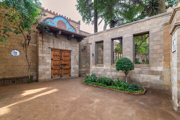 Courtyard in Prince Naguib Palace in Cairo shows a charming blend of lush greenery and traditional...