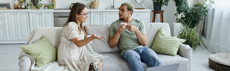 Two friends share laughter and stories in a comfortable home setting.