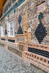 The Bottle House in Ganja, Azerbaijan showcases a complex design crafted from glass bottles and local materials, drawing visitors with its innovative architecture and lively facade