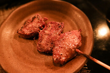 close up of Japanese grilled ox beef tongue skewer on a plate