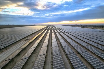 Aerial View of Solar Panels in a Renewable Energy Field at Sunrise - Sustainable Power Generation
