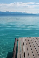 Obraz premium A serene wooden pier extends into tranquil turquoise waters, creating a sense of peace and endless summer horizons.