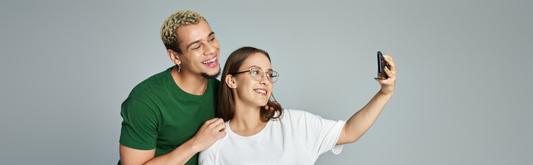 Two friends share laughter and smiles as they capture a fun selfie.