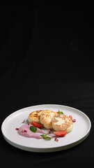 Cottage Cheese Pancakes with Berry Cream and Fresh Strawberries on a White Plate.