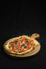 Margherita Pizza with Fresh Tomatoes and Basil on Wooden Board.