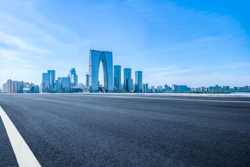 Empty asphalt road and cityscape with skyline in modern city