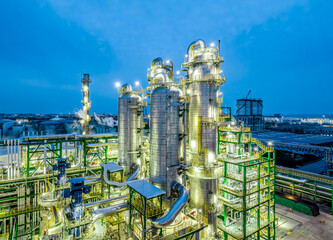 Oil refinery chemical plant industrial equipment buildings at night. Business Finance and Industry