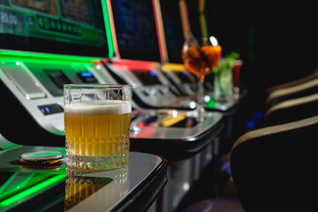 Whiskey sour on the background of slot machines in a casino. Casino concept.
