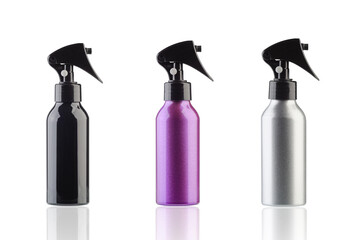Three multicolored hair spray bottles for haircut isolated on white