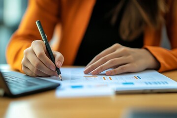 Businesswoman analyzing financial documents at office desk