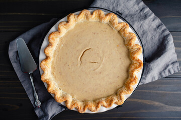 Homemade White Pumpkin Pie with Pie Server: Overhead view of a white pumpkin pie with a fluted crust in a ceramic pie dish