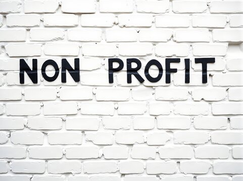 Simple black text on a white brick wall, signifying a nonprofit organization or initiative in a community setting