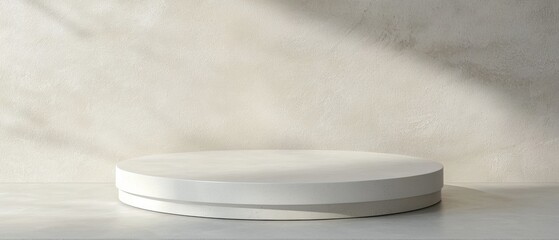 A white pedestal with a shadow on the wall