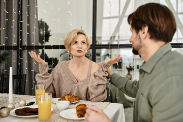 A couple shares a warm breakfast at home, filled with smiles and lively conversation.