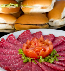 Catering with toamte, ham, salami, olives, orange juice, sandwiches on white bread and bran bread, cheese, vegetables, fruits, etc.