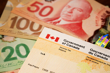 Canadian Government Income Tax Refund Cheque over dollar bills