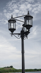 Street lamp in the sea. Garden lamp with black pole