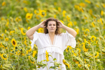 A Woman in White in a Field of Sunflowers: A Moment of Serenity Among Yellow Blossoms