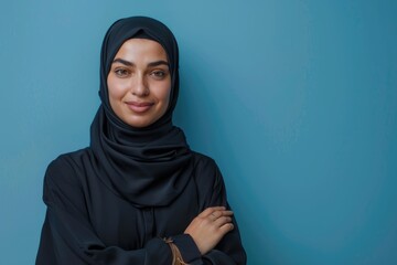 Naklejka premium Confident young Muslim woman in abaya and hijab portrait.