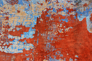 Old grunge wall with blue and red paint. Abstract background for design.