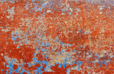 Old grunge wall with blue and red paint. Abstract background for design.