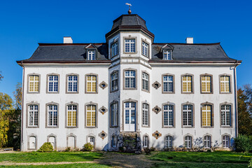 Zweibruggen Castle in classicist style, white walls with multiple windows, gabled roof and central tower with hexagonal dome, ruined main staircase, front view, Ubach-Palenberg, Germany