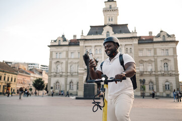 Delivery man using smartphone app for navigation while riding e scooter