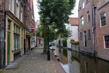 Houses with a water canal and boat in the old town of Alkmaar in the Netherlands