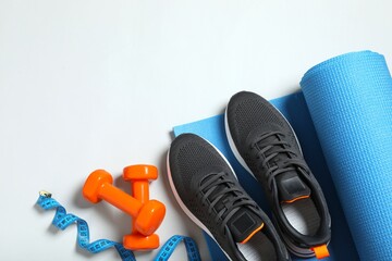 Sport equipment on color background, top view